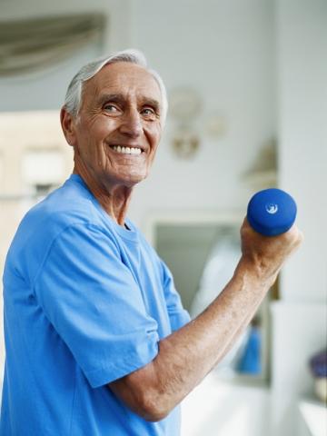 Picture of a smiling older adult performing harm curl with little weight 